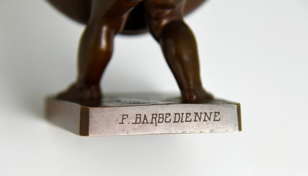 Antique bronze of a boy with basket