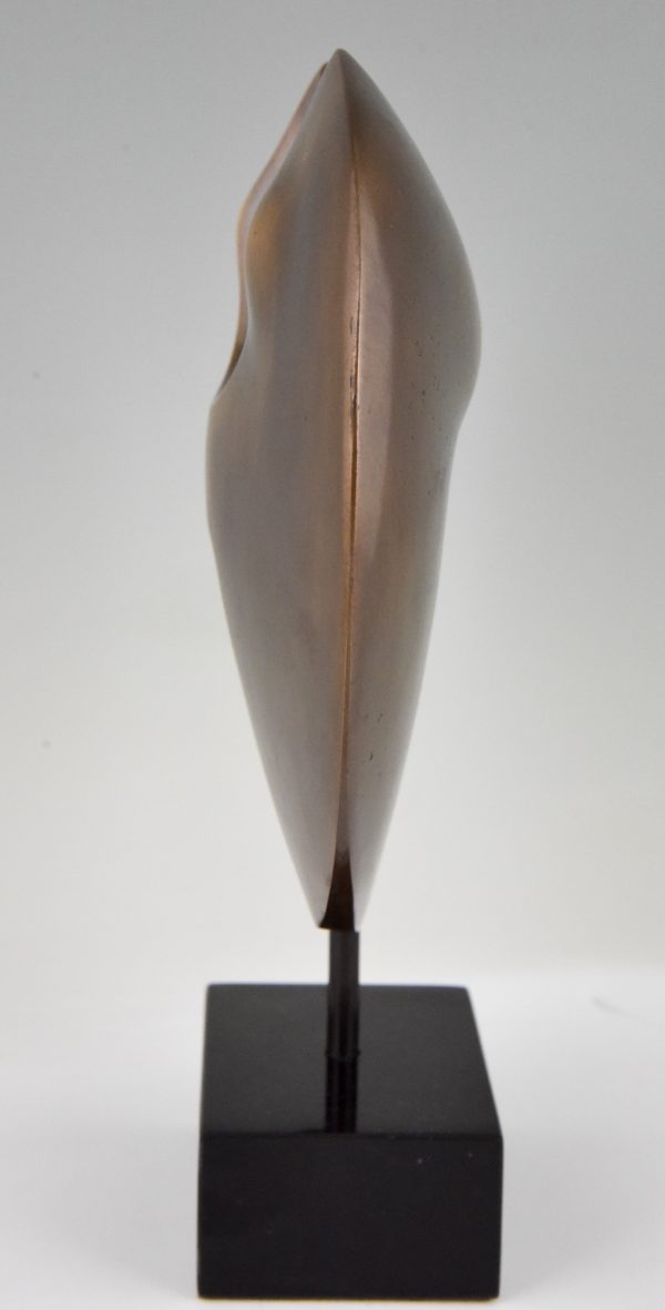 Abstract bronze sculpture on marble base