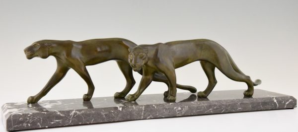 Art Deco sculpture of two walking panthers.