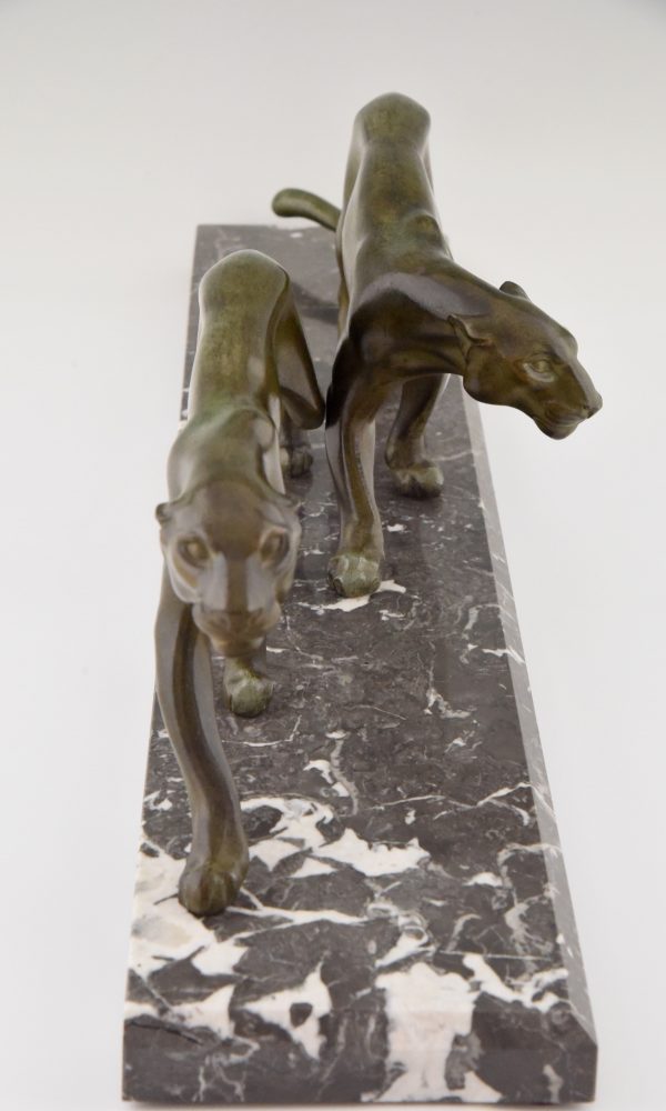 Art Deco sculpture of two walking panthers.