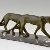 Art Deco sculpture of two walking panthers.