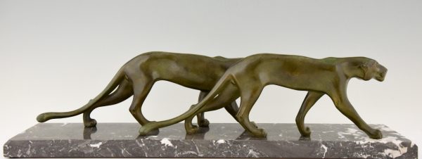 Art Deco sculpture of two walking panthers.