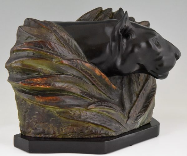 Art Deco sculpture of a panther head between bushes