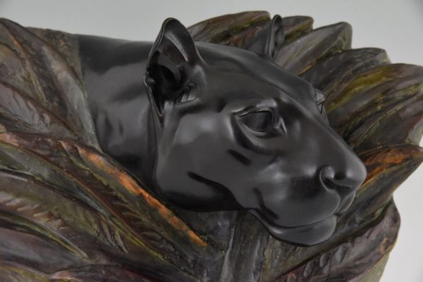 Art Deco sculpture of a panther head between bushes