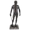 Antique bronze sculpture of a standing male nude fencer.