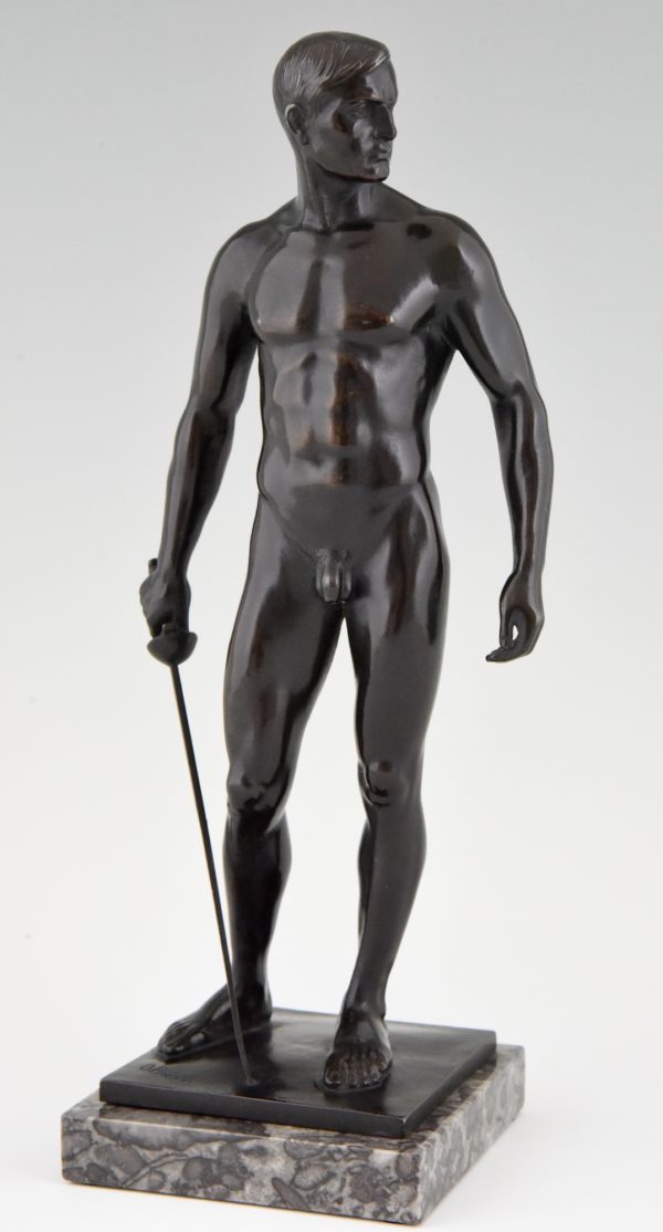 Antique bronze sculpture of a standing male nude fencer.