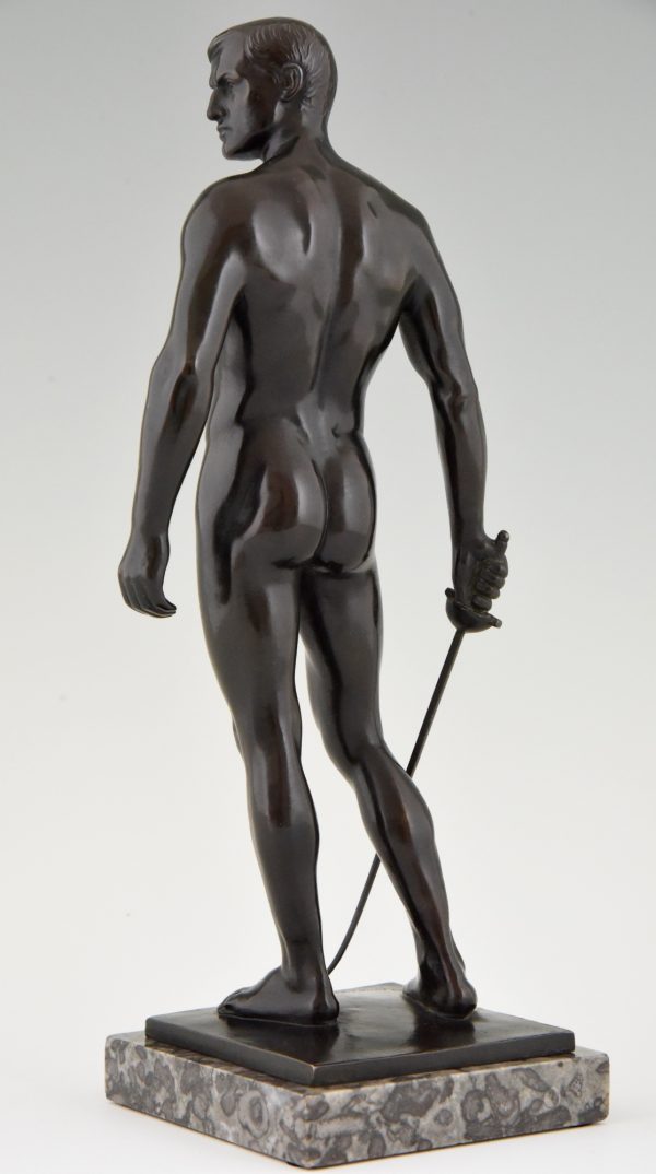 Antique bronze sculpture of a standing male nude fencer.