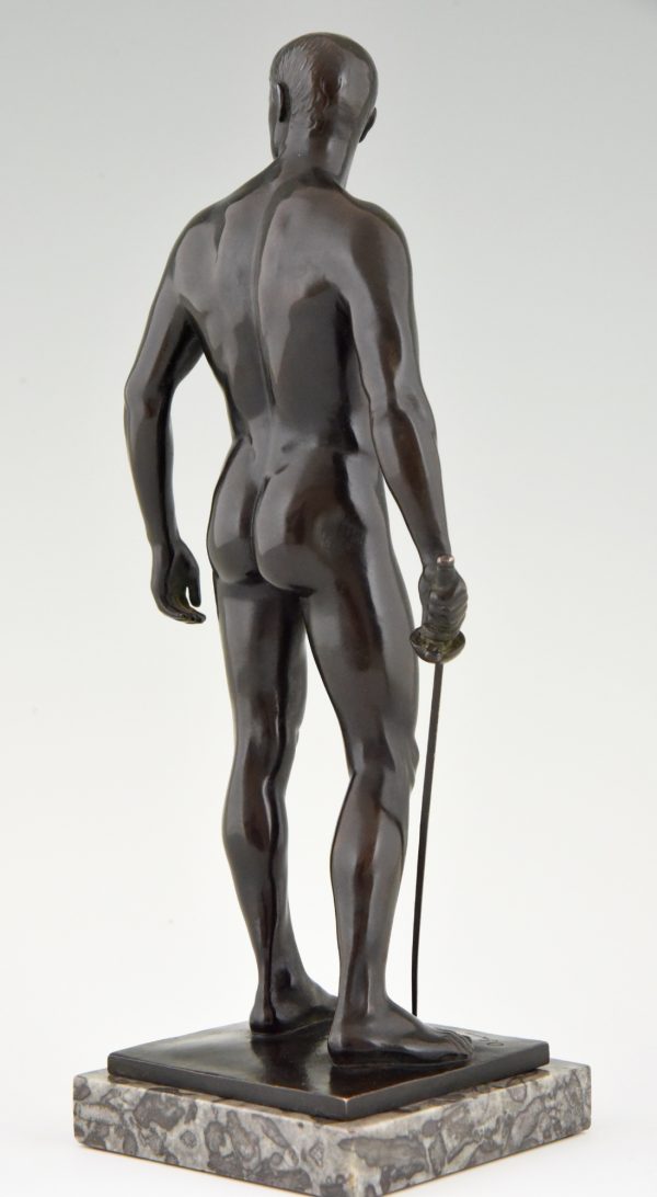 Antique bronze sculpture of a standing male nude fencer.