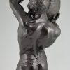 Antique bronze sculpture of a male nude athlete with stone.