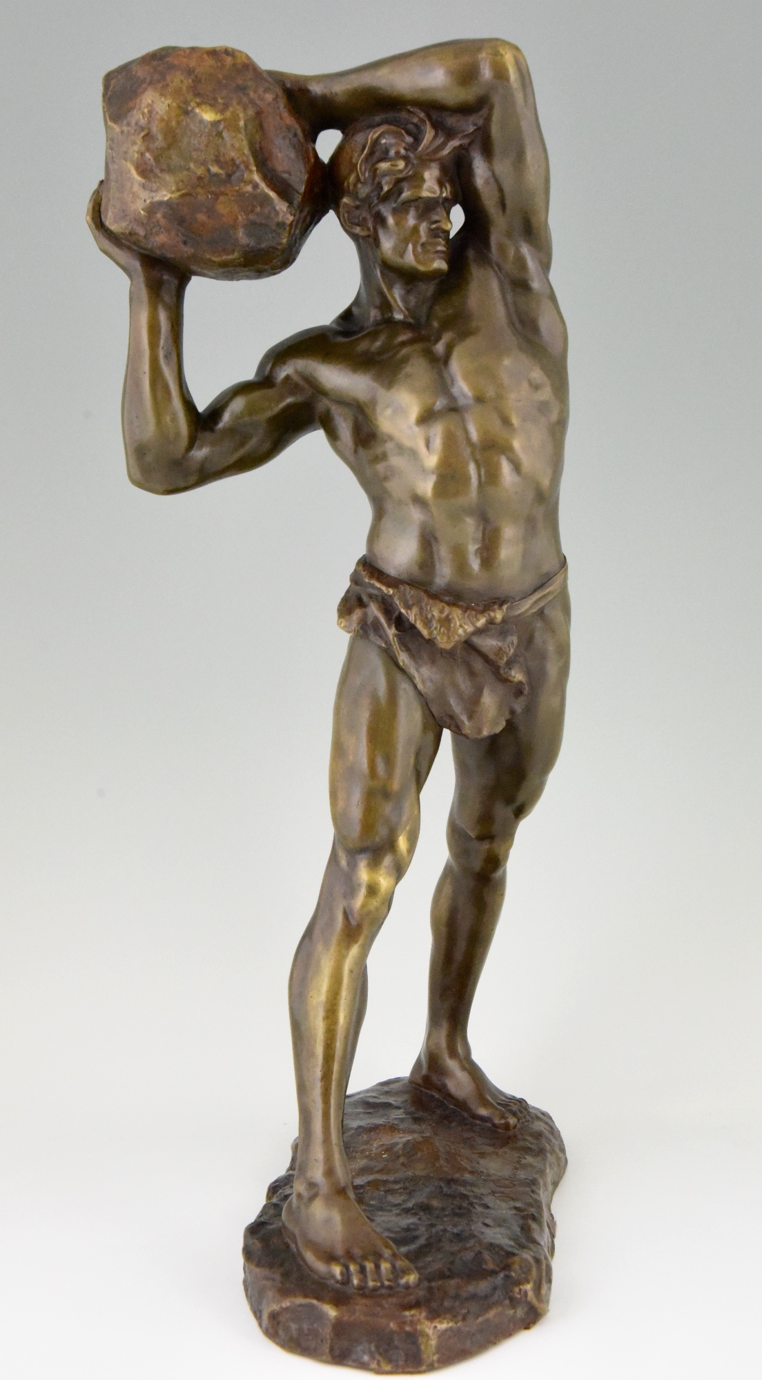 Antique bronze sculpture strong man, male nude with stone