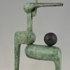 Modern bronze sculpture figure with ball.