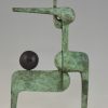 Modern bronze sculpture figure with ball.