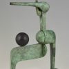 Modern bronze sculpture figure with ball.