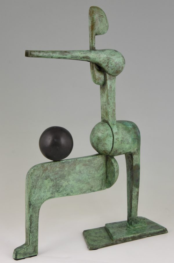 Modern bronze sculpture figure with ball.