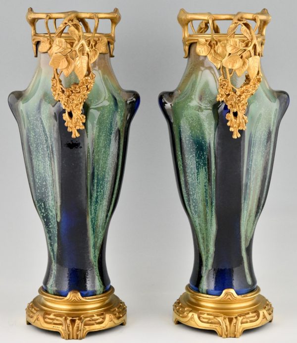 Impressive pair of Art Nouveau ceramic and bronze vases