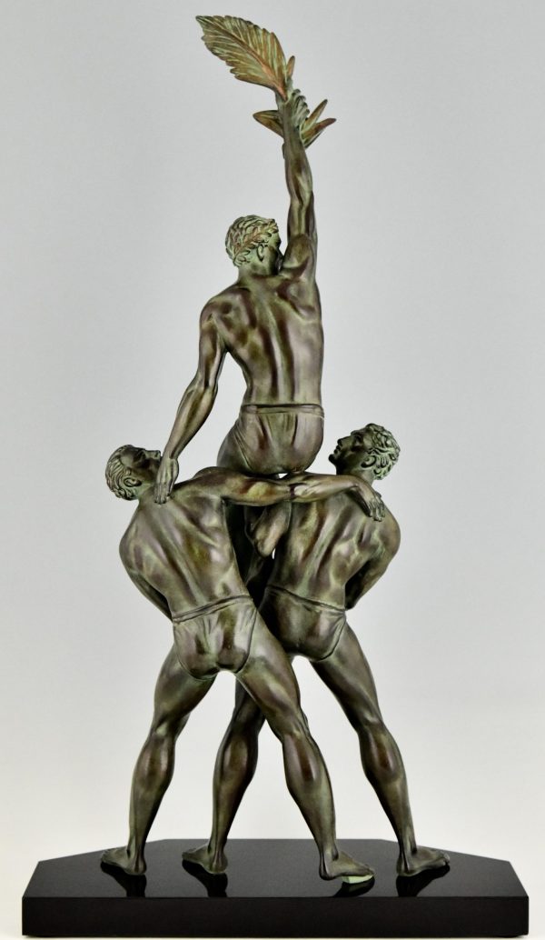 Art Deco sculpture of 3 athletes with palm leaf