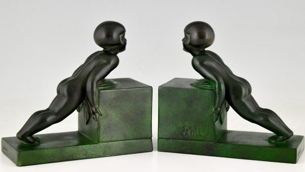 Art Deco child bookends, little girls pushing a cube.