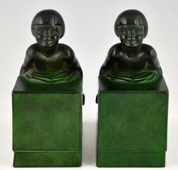 Art Deco child bookends, little girls pushing a cube.