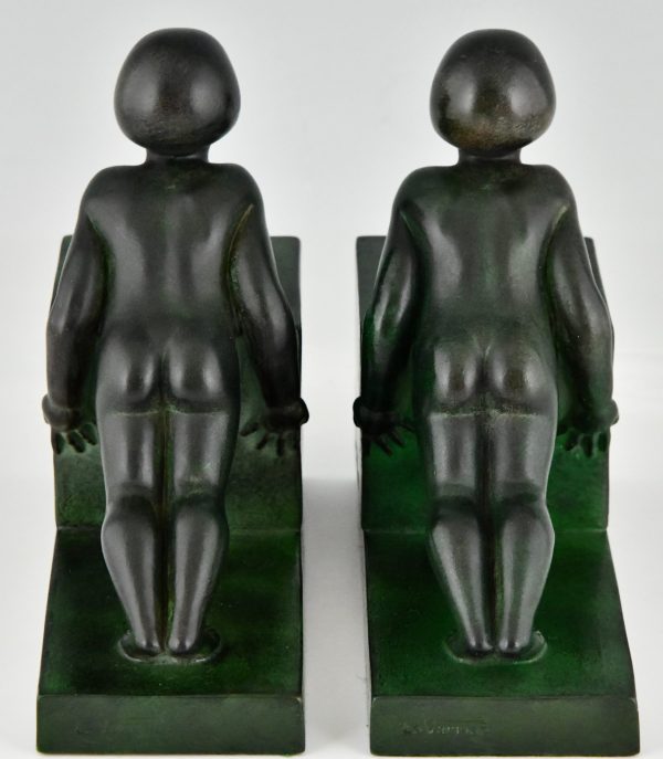 Art Deco child bookends, little girls pushing a cube.