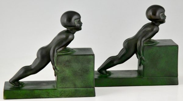 Art Deco child bookends, little girls pushing a cube.