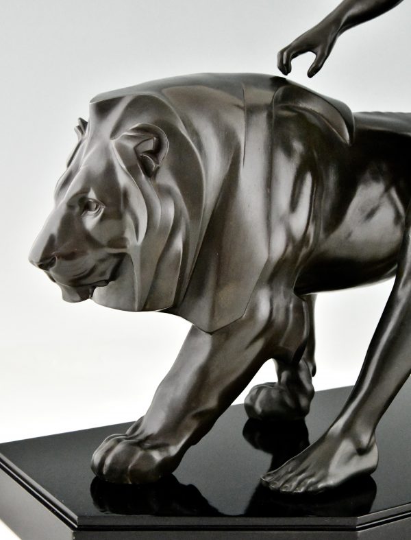 Art Deco sculpture of a male nude walking with lion Belluaire