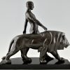 Art Deco sculpture of a male nude walking with lion Belluaire