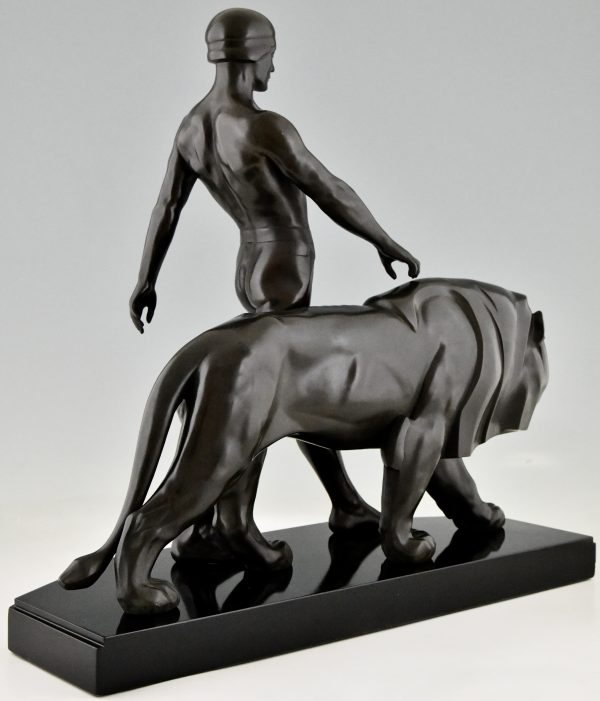 Art Deco sculpture of a male nude walking with lion Belluaire