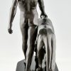 Art Deco sculpture of a male nude walking with lion Belluaire