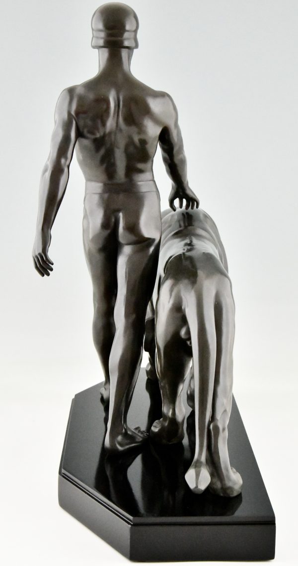 Art Deco sculpture of a male nude walking with lion Belluaire