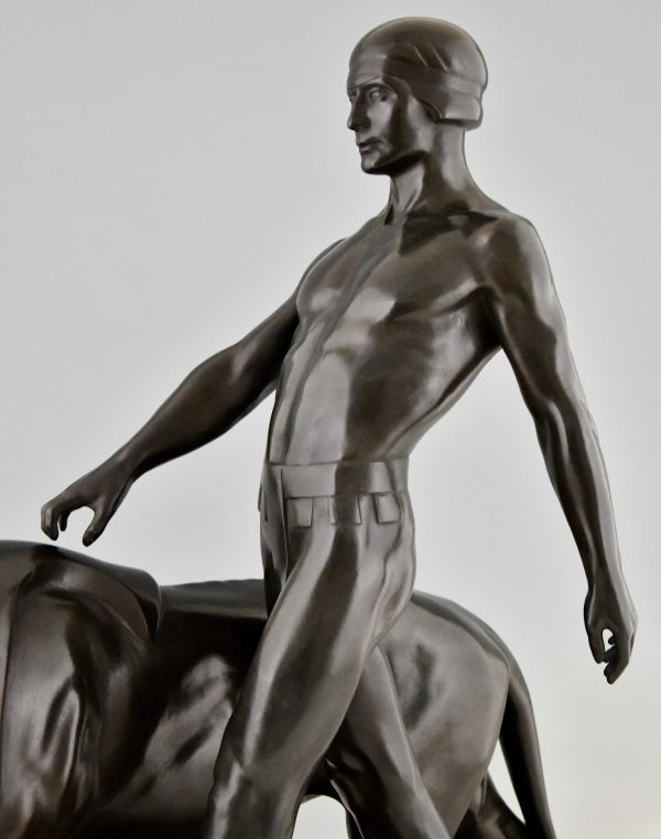 Art Deco sculpture of a male nude walking with lion Belluaire