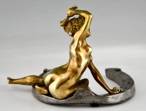 Art Nouveau bronze sculpture nude on a horseshoe. 