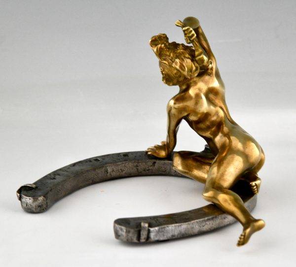 Art Nouveau bronze sculpture nude on a horseshoe.  