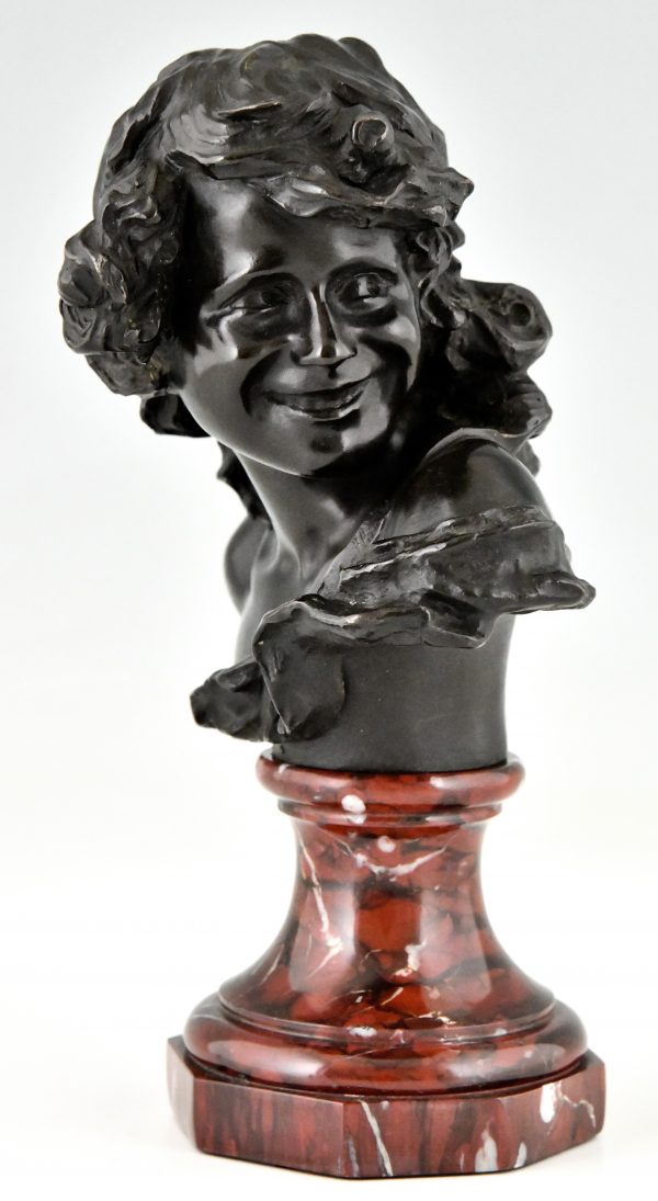 Antique bronze bust of a smiling child.