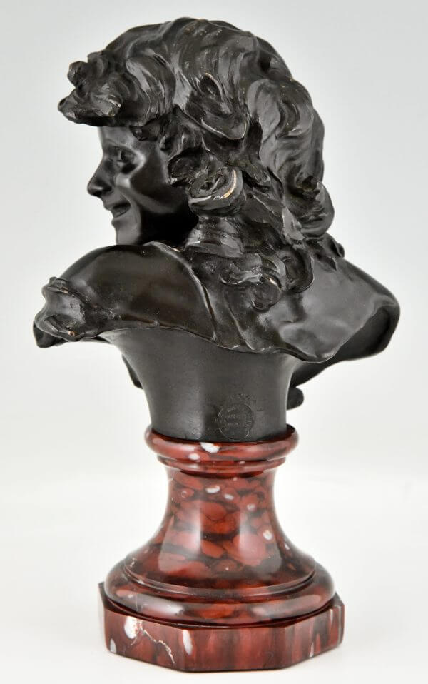 Antique bronze bust of a smiling child.