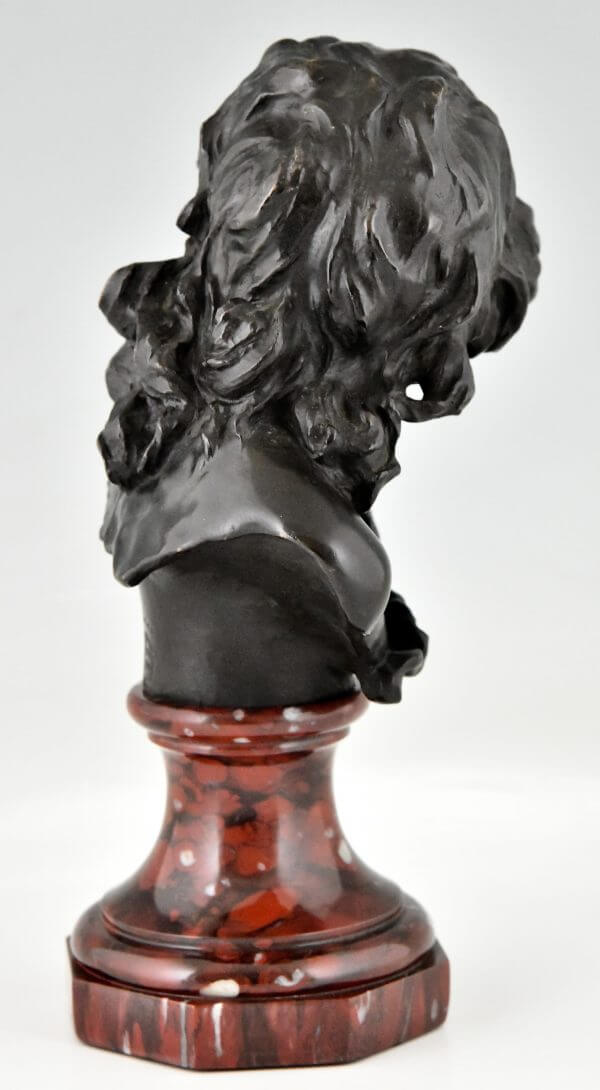 Antique bronze bust of a smiling child.