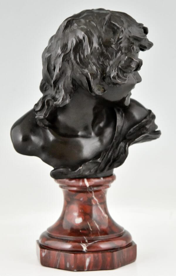 Antique bronze bust of a smiling child.