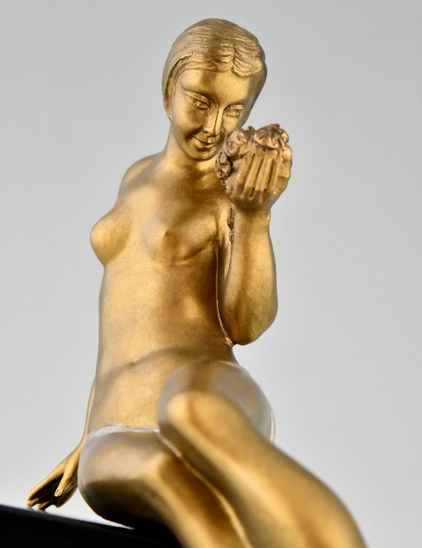 Art Deco bronze sculpture seated nude with flowers.