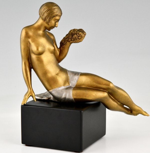 Art Deco bronze sculpture seated nude with flowers.