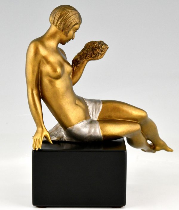 Art Deco bronze sculpture seated nude with flowers.