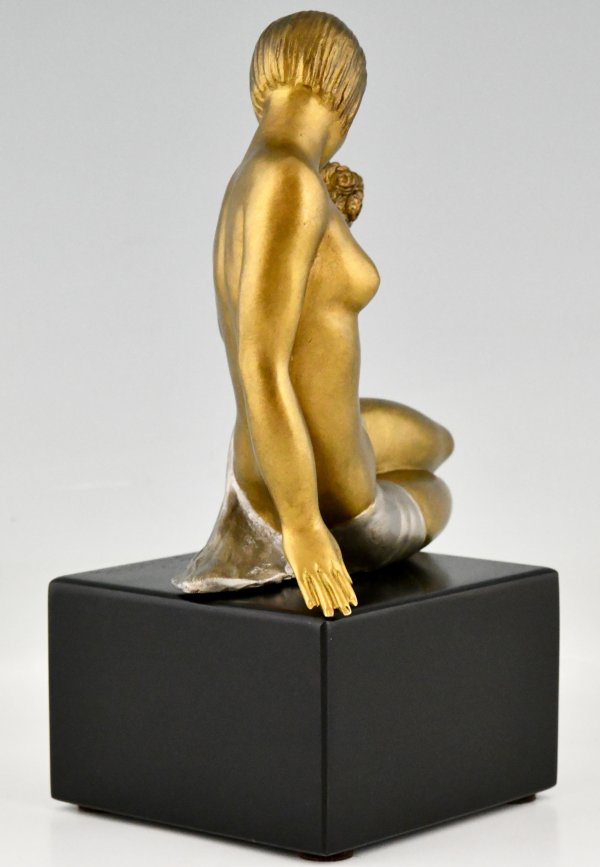 Art Deco bronze sculpture seated nude with flowers.