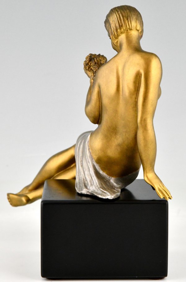 Art Deco bronze sculpture seated nude with flowers.