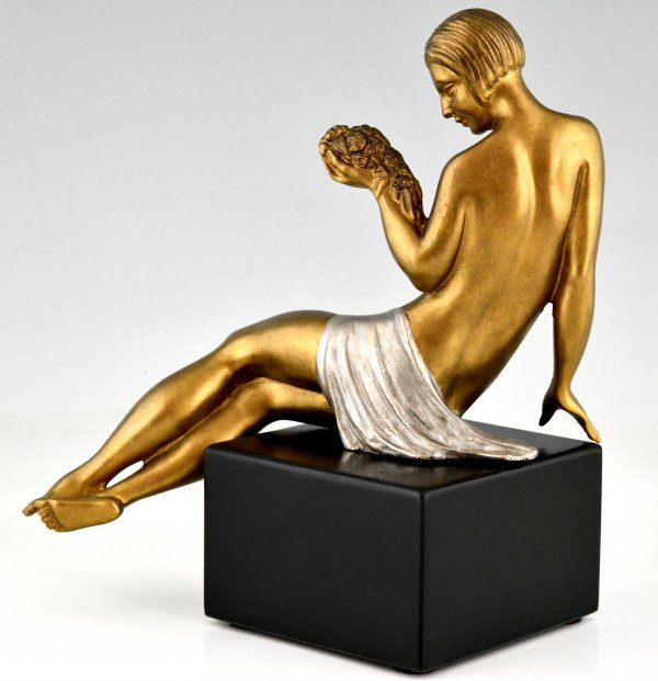 Art Deco bronze sculpture seated nude with flowers.