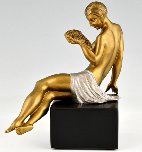 Art Deco bronze sculpture seated nude with flowers.