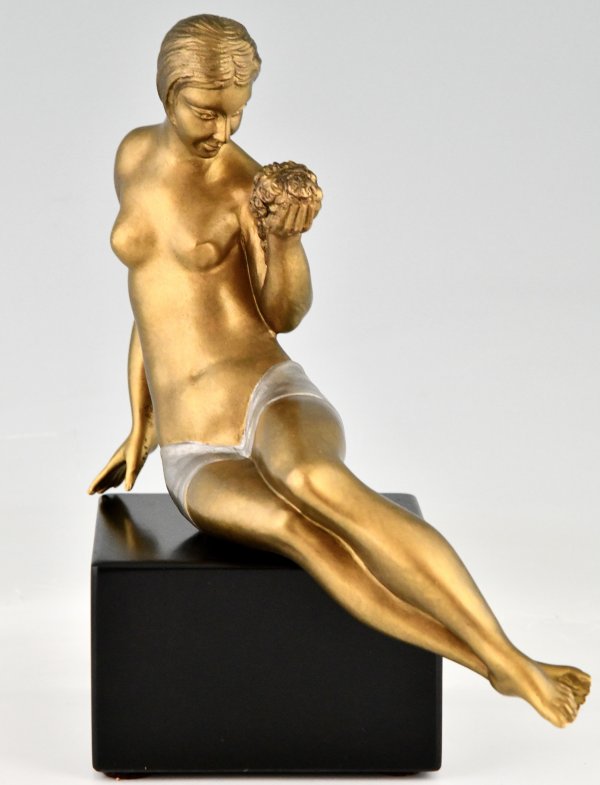 Art Deco bronze sculpture seated nude with flowers.