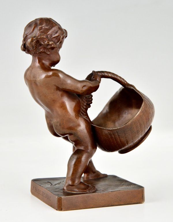 Antique bronze sculpture boy with basket.