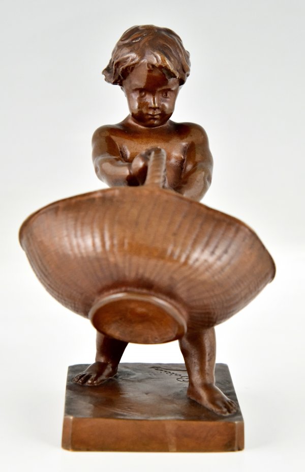 Antique bronze sculpture boy with basket.