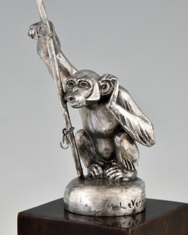 Art Deco monkey carmascot with flag pole.