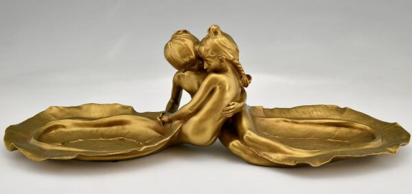 Art Nouveau bronze tray with young couple kissing.