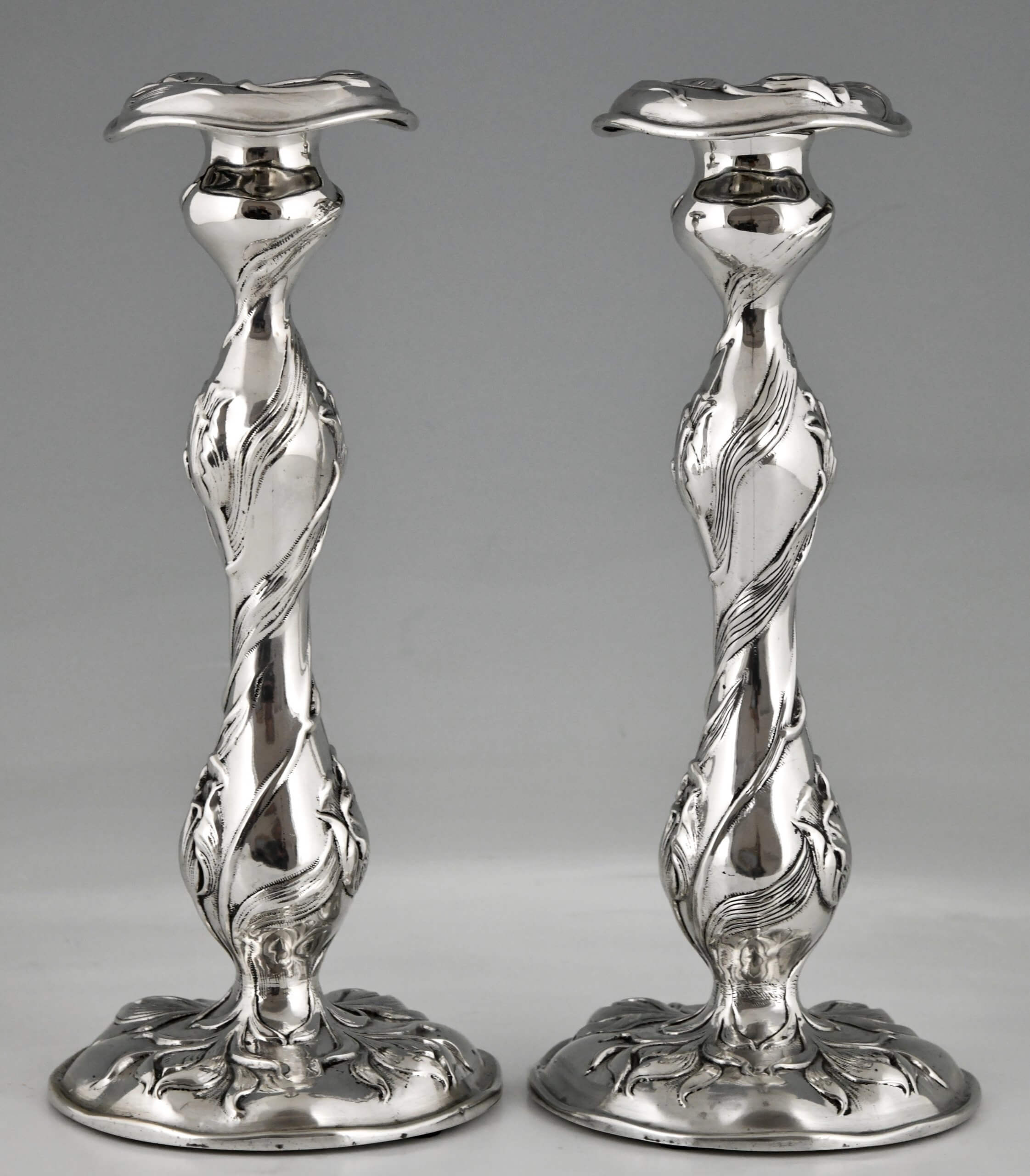 American silver Art Nouveau candlesticks with flowers.