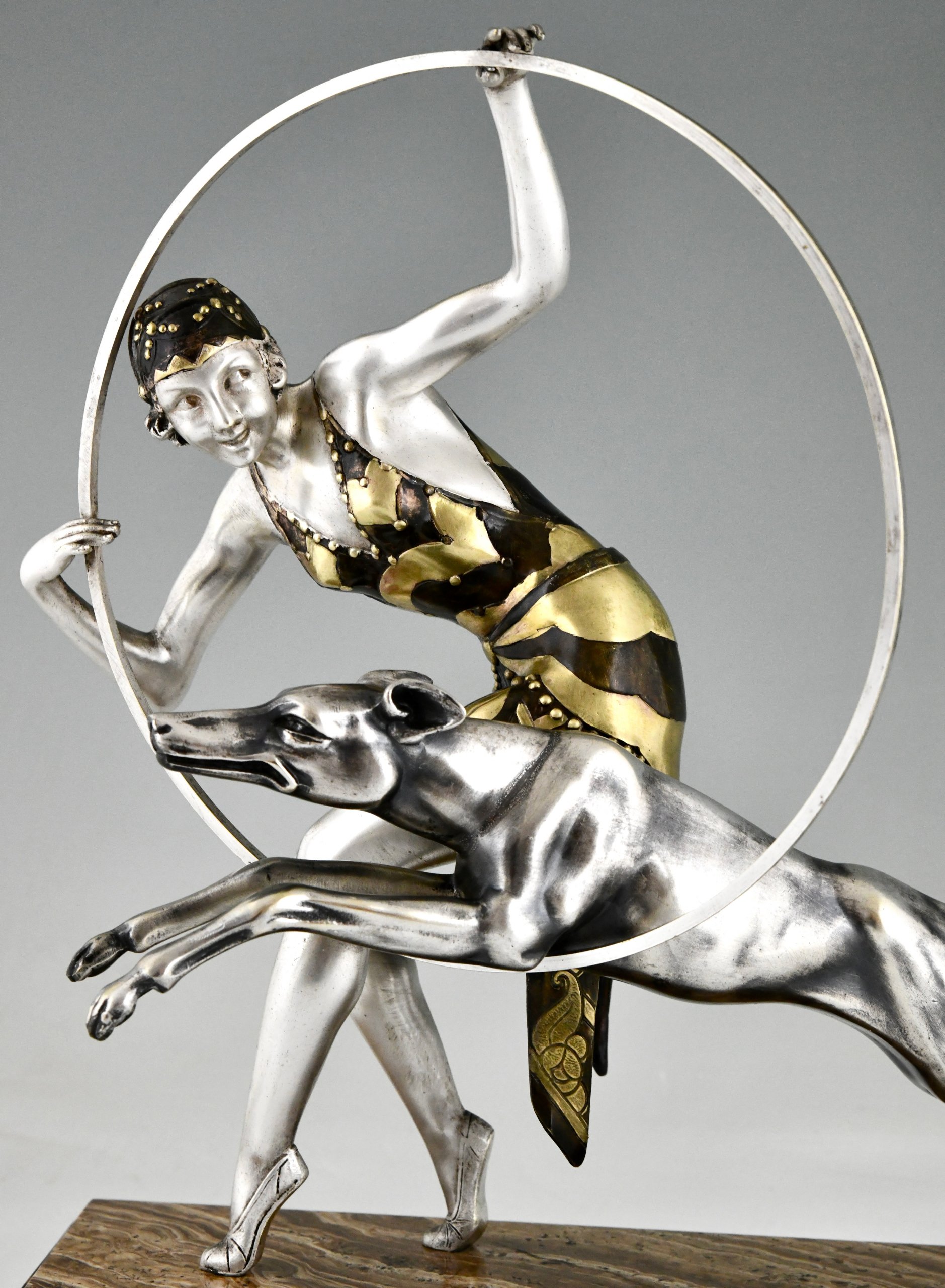 Art Deco sculpture hoop dancer with dog.